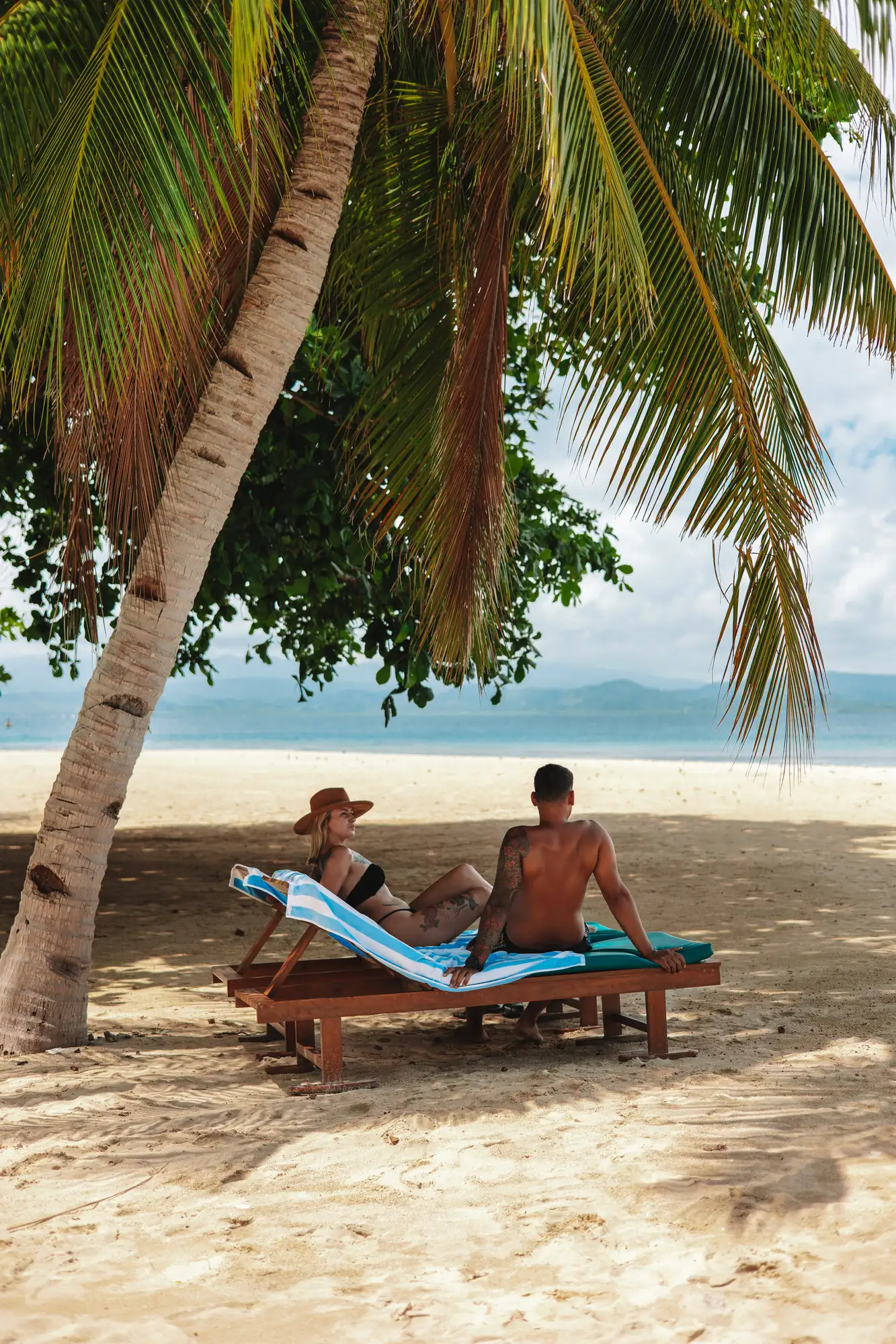 Sunbathing on the beach at Lotus Gangga Island Resort